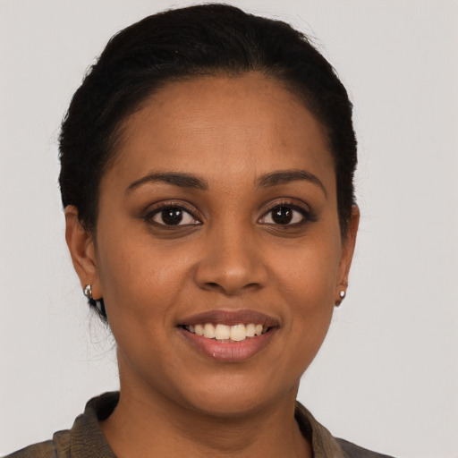 Joyful latino young-adult female with short  brown hair and brown eyes