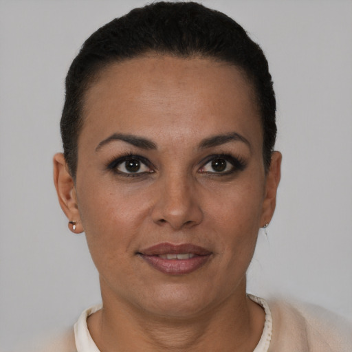 Joyful latino young-adult female with short  brown hair and brown eyes