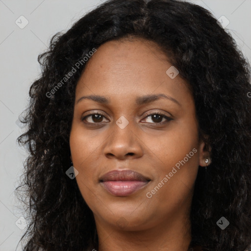 Joyful black young-adult female with long  black hair and brown eyes