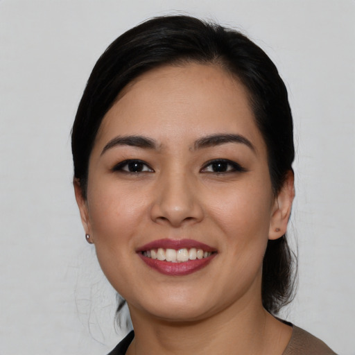 Joyful asian young-adult female with medium  brown hair and brown eyes