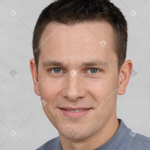 Joyful white adult male with short  brown hair and brown eyes