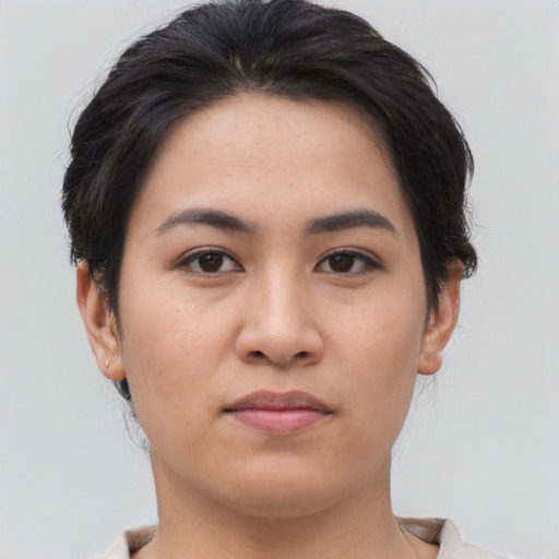 Joyful asian young-adult female with medium  brown hair and brown eyes