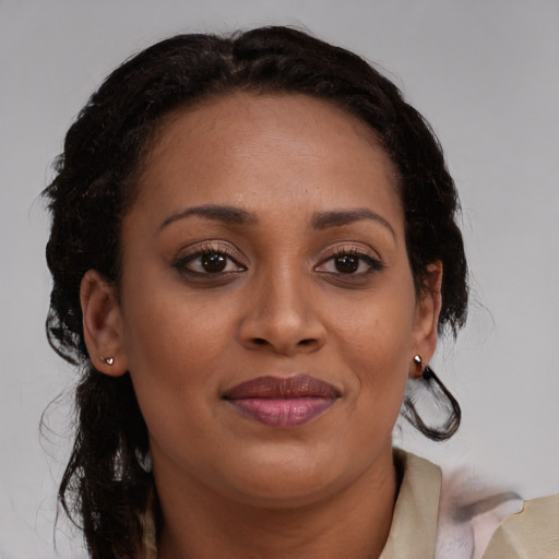 Joyful black young-adult female with medium  brown hair and brown eyes