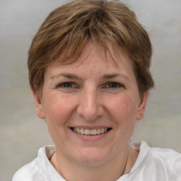 Joyful white adult female with short  brown hair and grey eyes