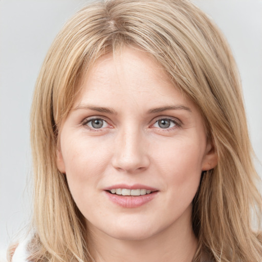 Joyful white young-adult female with long  brown hair and blue eyes