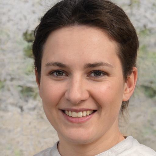 Joyful white young-adult female with short  brown hair and grey eyes