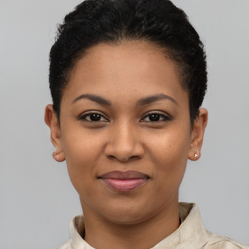 Joyful latino young-adult female with short  black hair and brown eyes