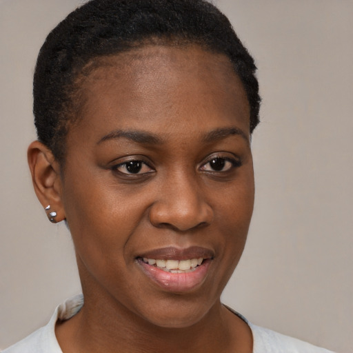 Joyful black young-adult female with short  brown hair and brown eyes