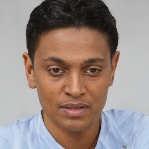 Joyful latino young-adult male with short  brown hair and brown eyes