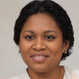 Joyful black adult female with medium  brown hair and brown eyes