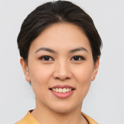 Joyful asian young-adult female with short  brown hair and brown eyes