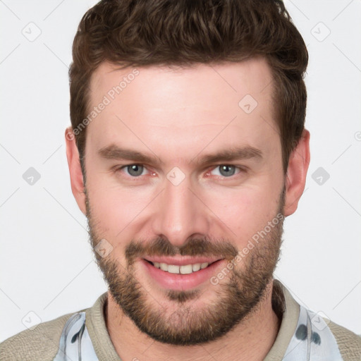 Joyful white young-adult male with short  brown hair and blue eyes