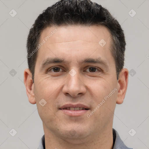 Joyful white adult male with short  brown hair and brown eyes