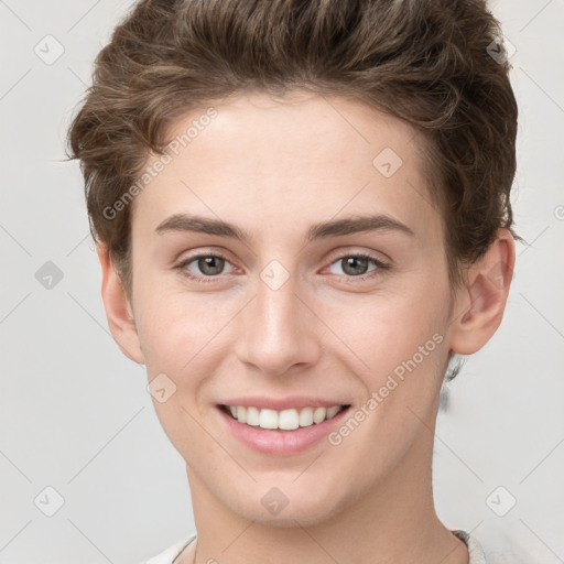 Joyful white young-adult female with short  brown hair and grey eyes