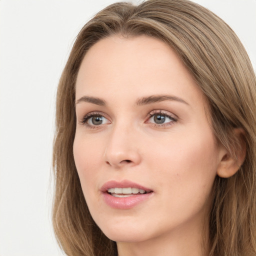 Joyful white young-adult female with long  brown hair and green eyes