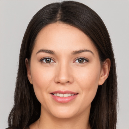 Joyful white young-adult female with long  brown hair and brown eyes