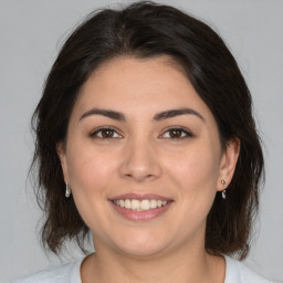 Joyful white young-adult female with medium  brown hair and brown eyes