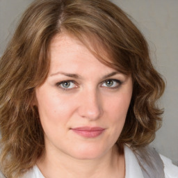 Joyful white young-adult female with medium  brown hair and blue eyes