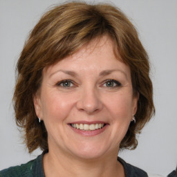 Joyful white adult female with medium  brown hair and grey eyes