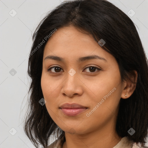 Joyful latino young-adult female with medium  brown hair and brown eyes