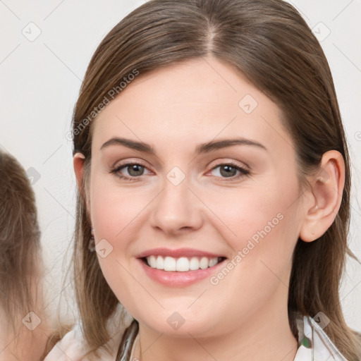 Joyful white young-adult female with long  brown hair and grey eyes