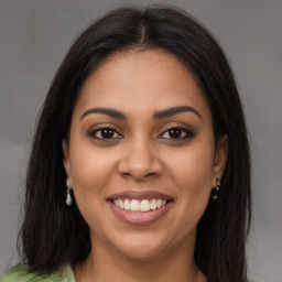 Joyful latino young-adult female with long  brown hair and brown eyes