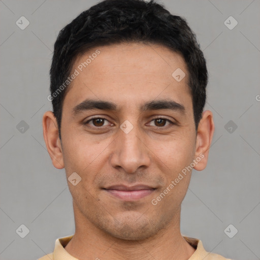 Joyful white young-adult male with short  black hair and brown eyes