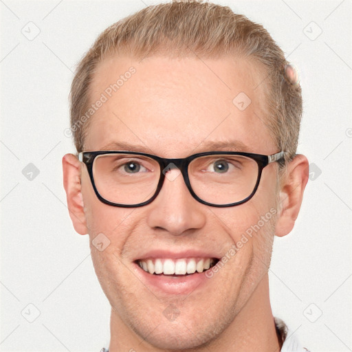 Joyful white adult male with short  brown hair and blue eyes