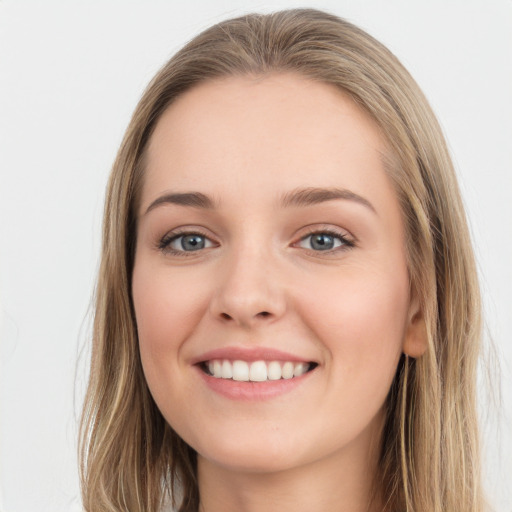 Joyful white young-adult female with long  brown hair and grey eyes