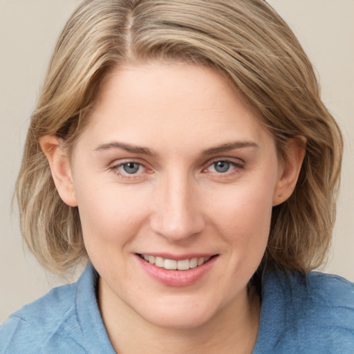 Joyful white young-adult female with medium  brown hair and blue eyes