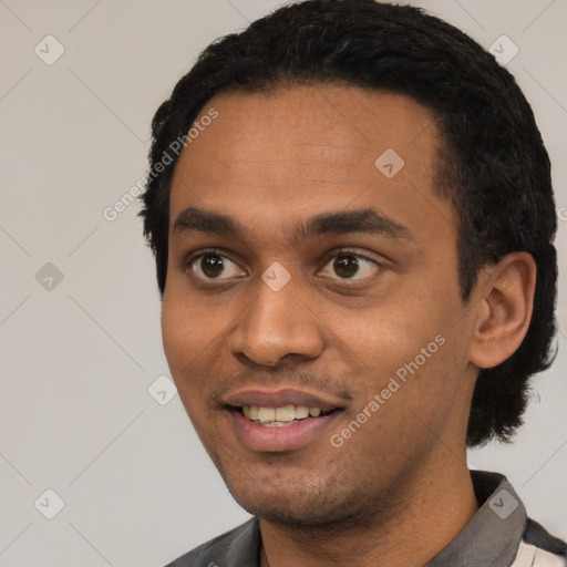 Joyful black young-adult male with short  black hair and brown eyes