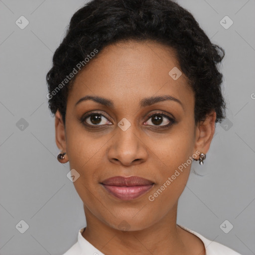 Joyful black young-adult female with short  black hair and brown eyes