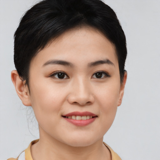Joyful asian young-adult female with short  brown hair and brown eyes