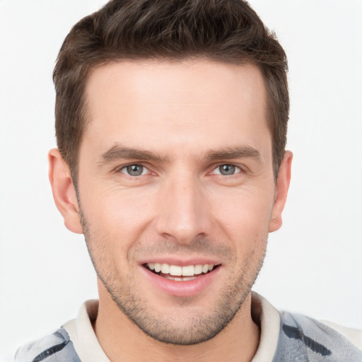 Joyful white young-adult male with short  brown hair and grey eyes