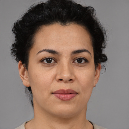 Joyful latino adult female with short  brown hair and brown eyes