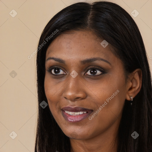 Joyful black young-adult female with long  black hair and brown eyes