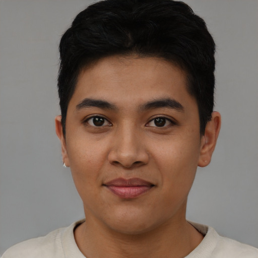 Joyful asian young-adult male with short  black hair and brown eyes
