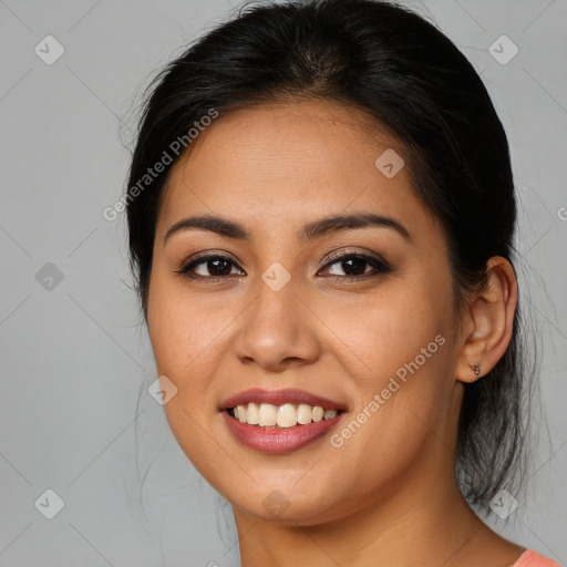 Joyful latino young-adult female with medium  brown hair and brown eyes