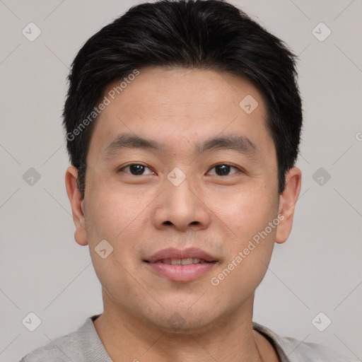 Joyful asian young-adult male with short  brown hair and brown eyes