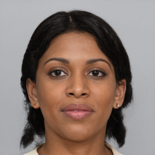 Joyful black young-adult female with medium  black hair and brown eyes