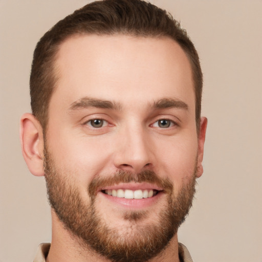 Joyful white young-adult male with short  brown hair and grey eyes