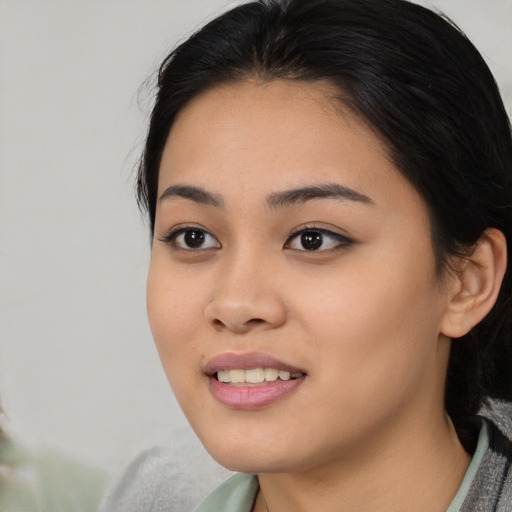 Joyful asian young-adult female with medium  black hair and brown eyes
