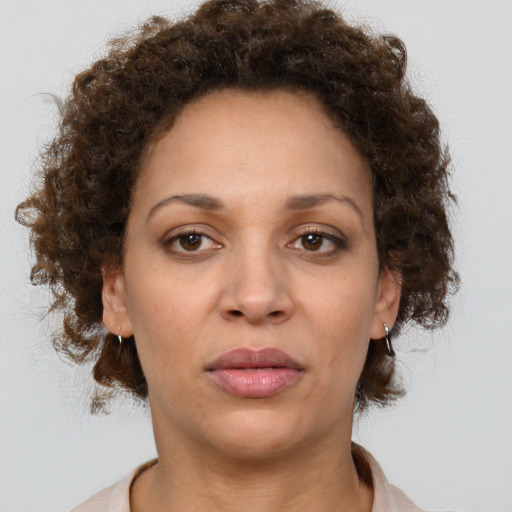 Joyful black adult female with medium  brown hair and brown eyes