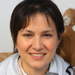 Joyful white adult female with medium  brown hair and brown eyes