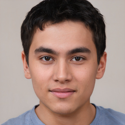 Joyful asian young-adult male with short  brown hair and brown eyes