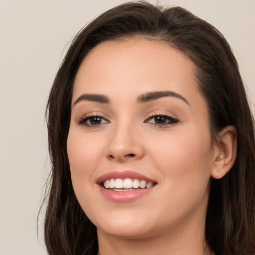 Joyful white young-adult female with long  brown hair and brown eyes