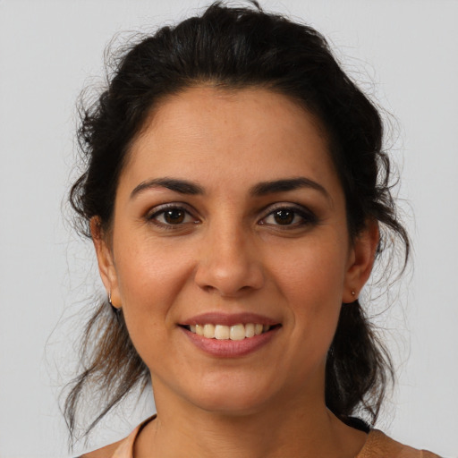 Joyful latino young-adult female with medium  brown hair and brown eyes