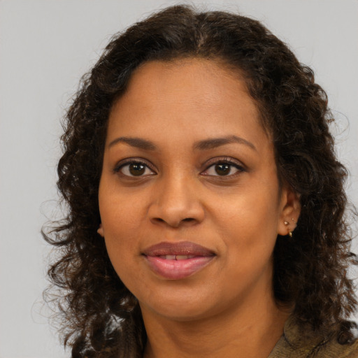 Joyful black young-adult female with medium  brown hair and brown eyes
