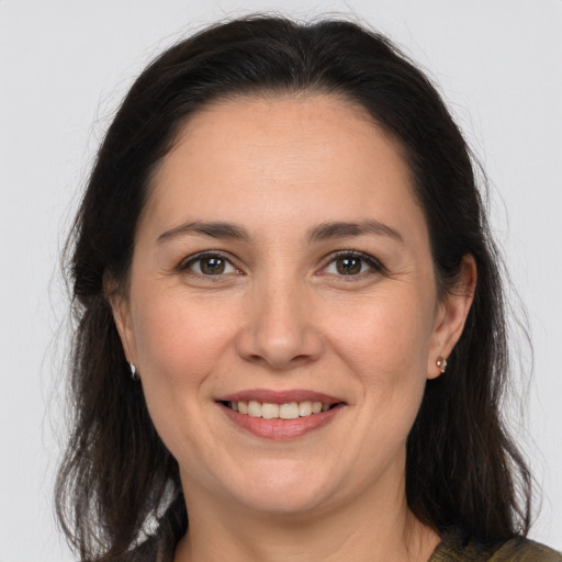 Joyful white adult female with medium  brown hair and brown eyes