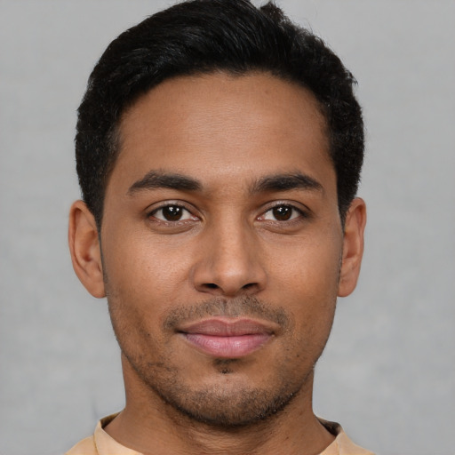 Joyful latino young-adult male with short  brown hair and brown eyes